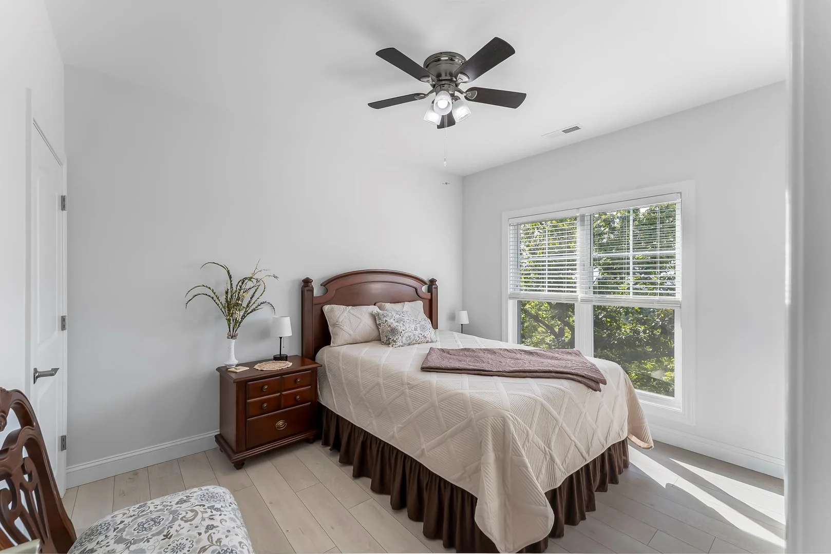 Bedroom with winow to the left and closet to the right