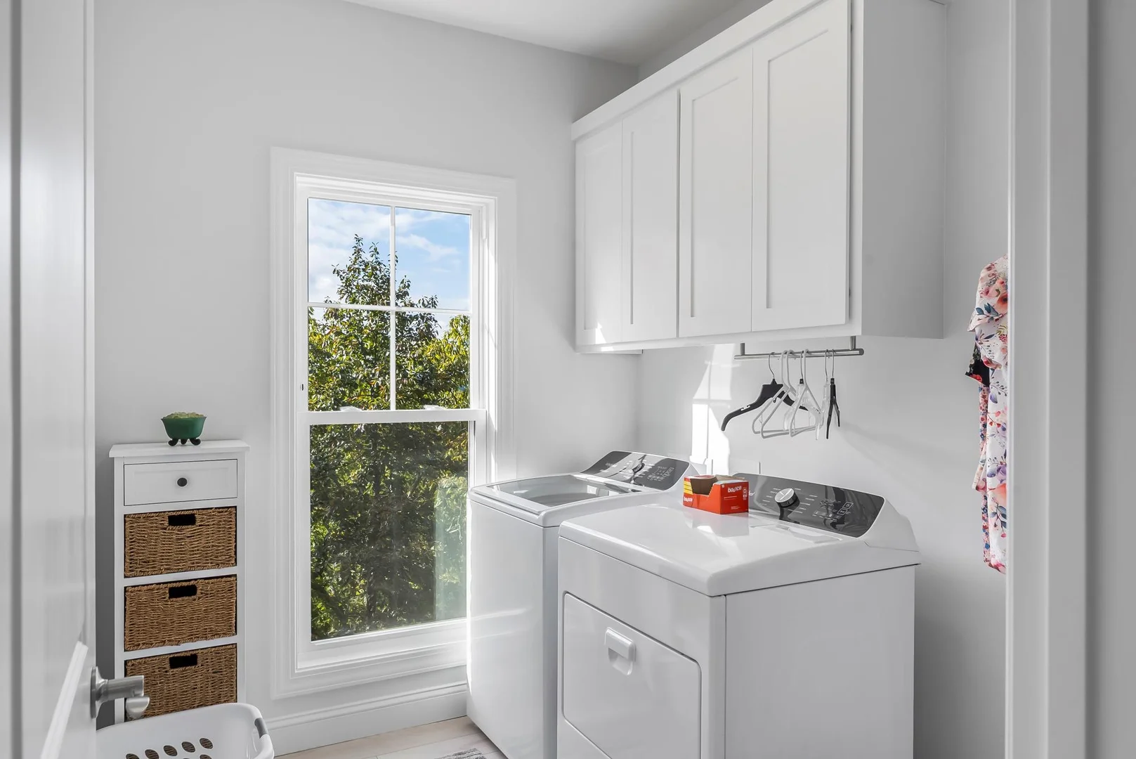 Laundry room with windows to the left and washer and dryer to the right