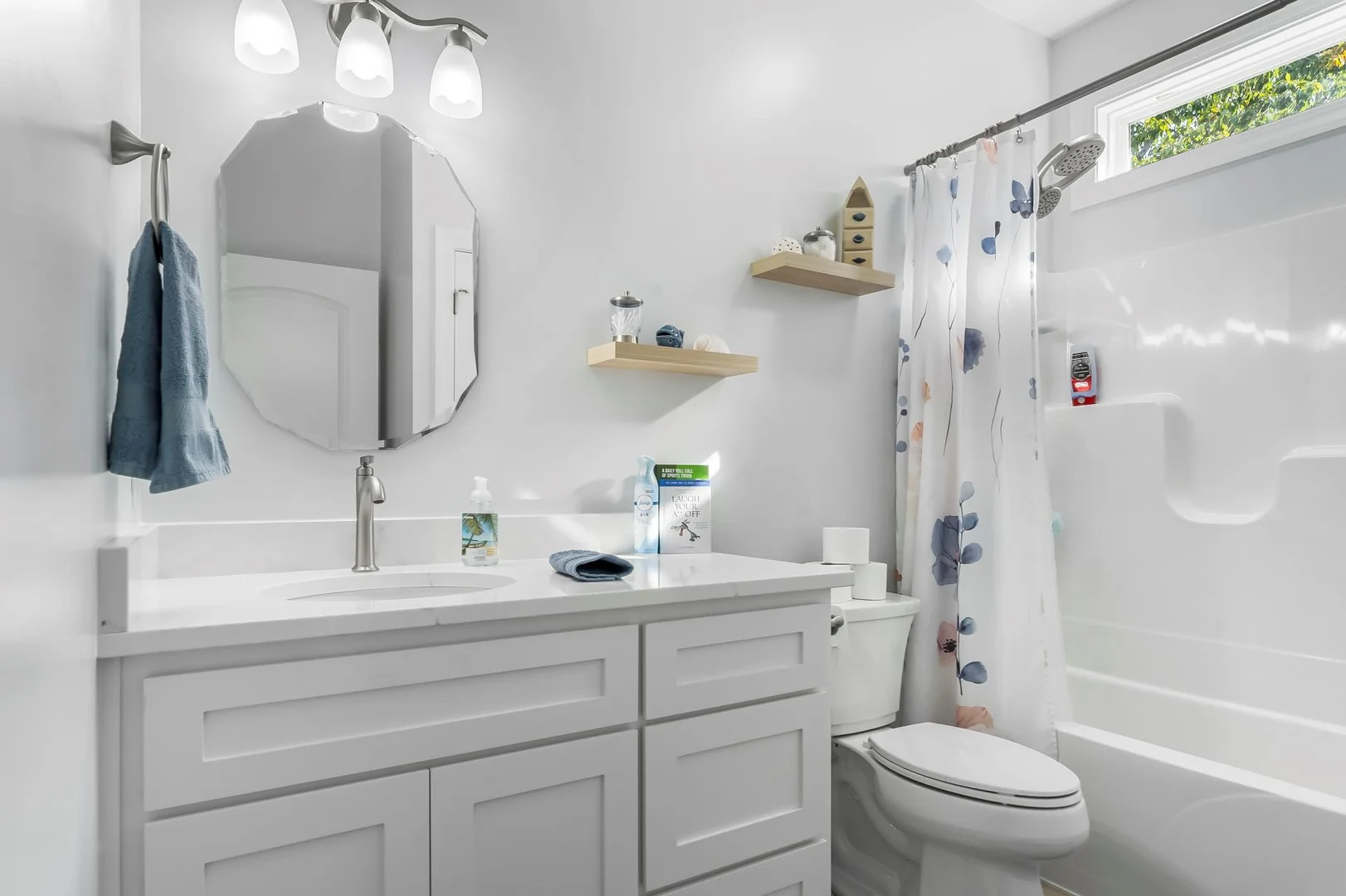 bathroom with bathtub and large sink window over bath tub